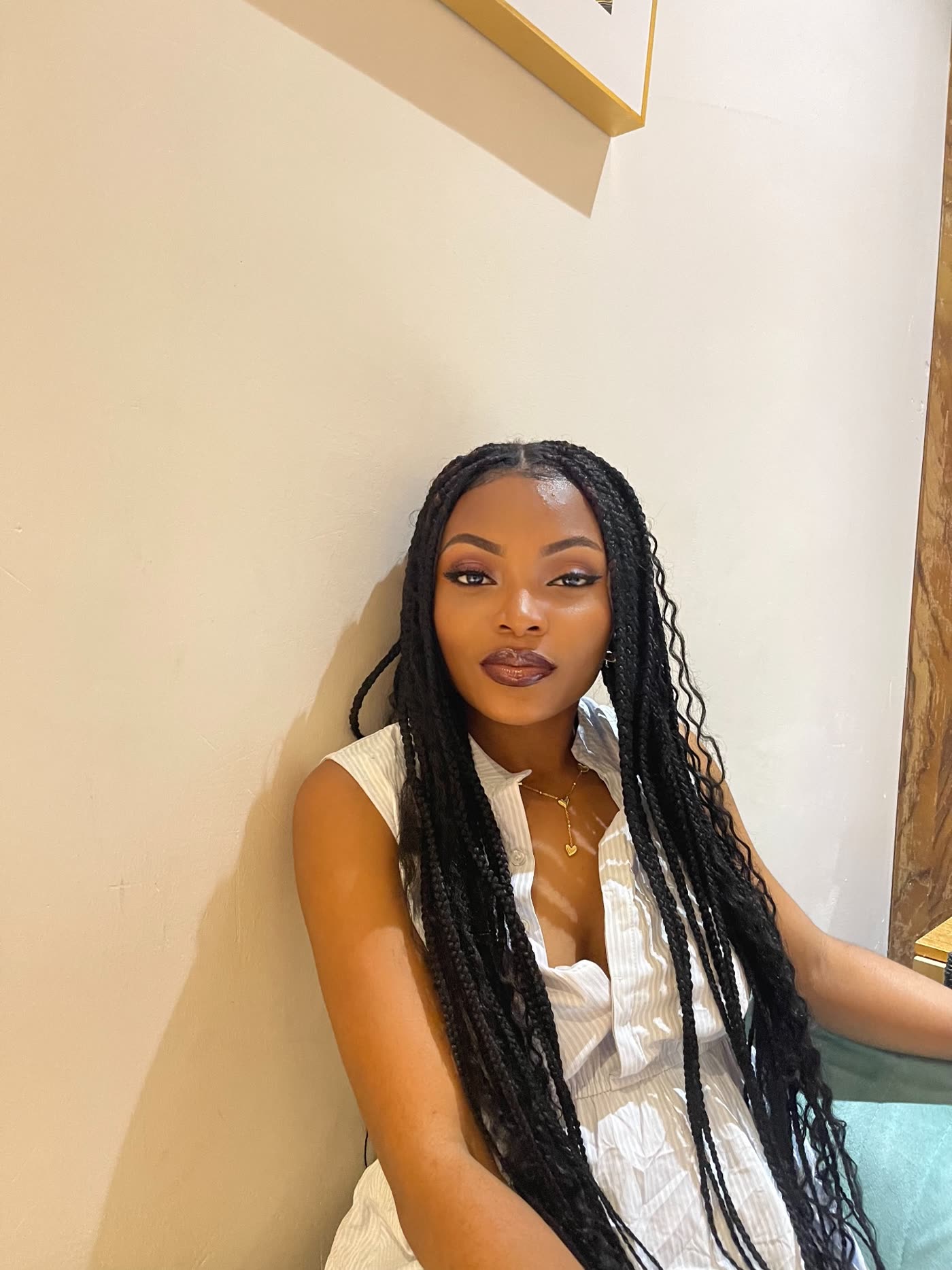 Deborah Christian in a white dress with long braids