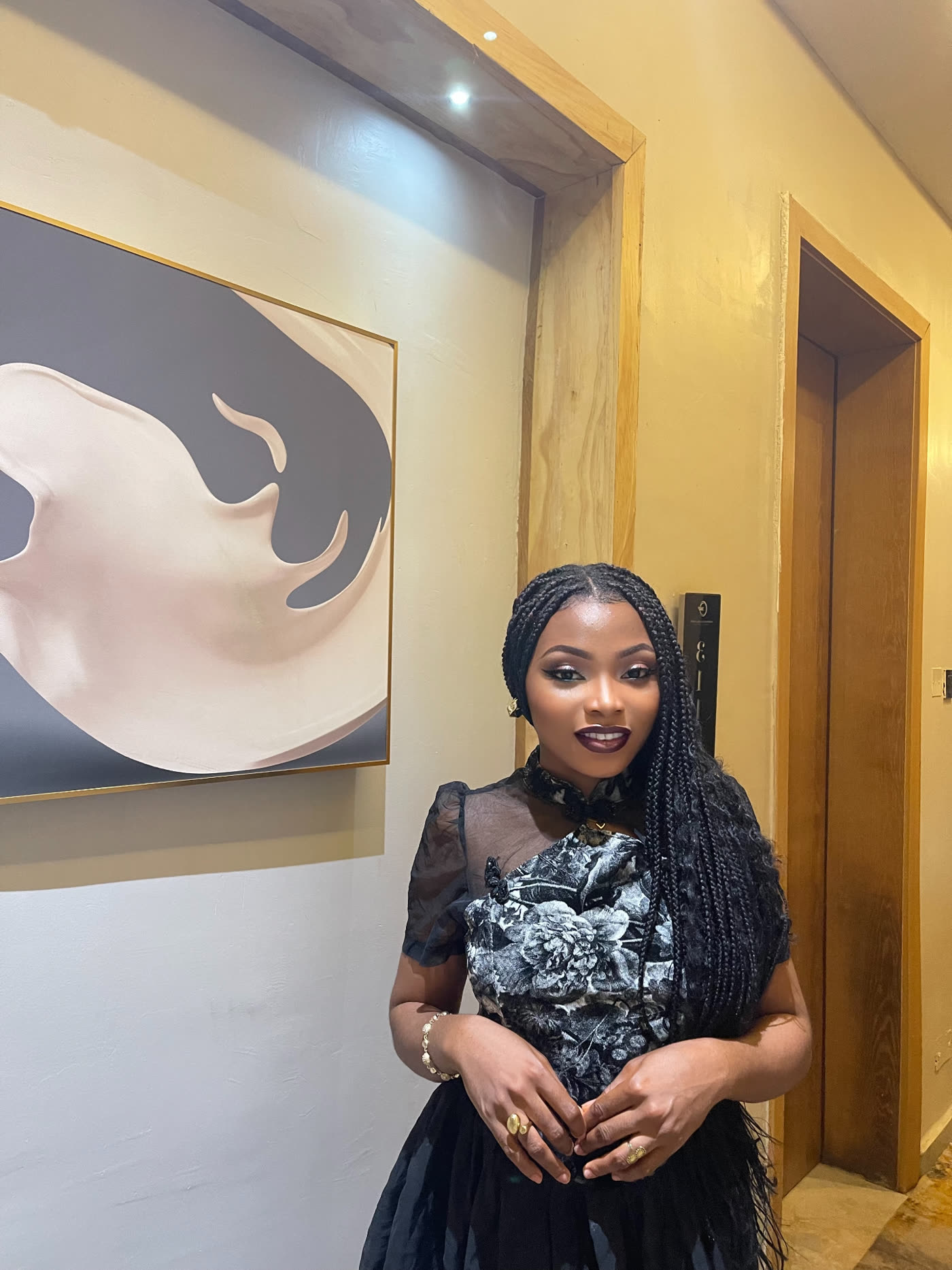 Deborah Christian standing in a black floral gown