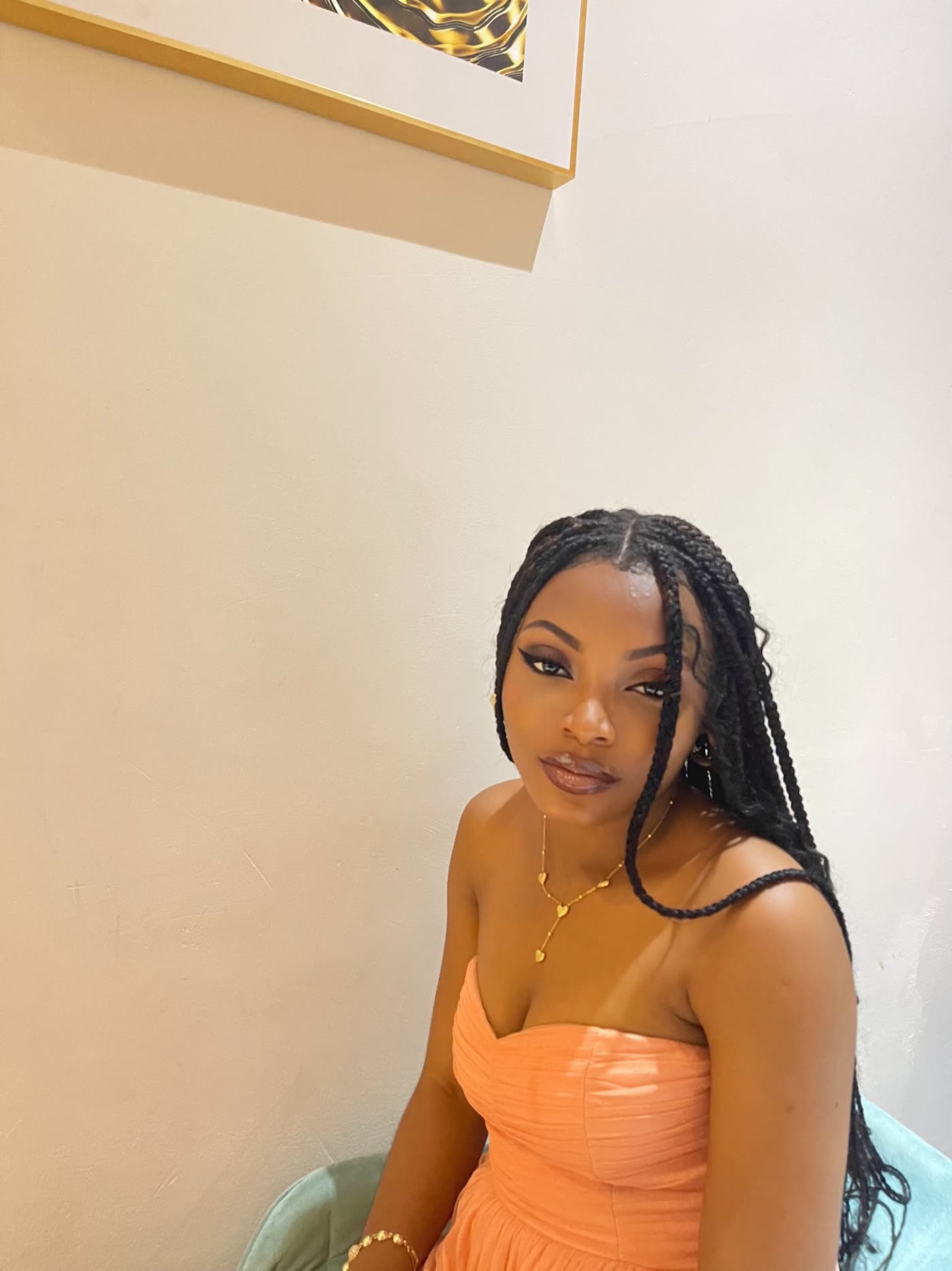 Deborah Christian seated in a peach dress